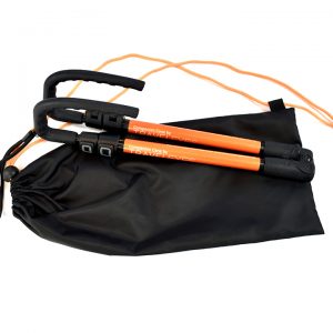 Photo description: The cane is fully collapsed with it's orange TE label on show. The cane lies on top of a black drawstring bag, with orange strings