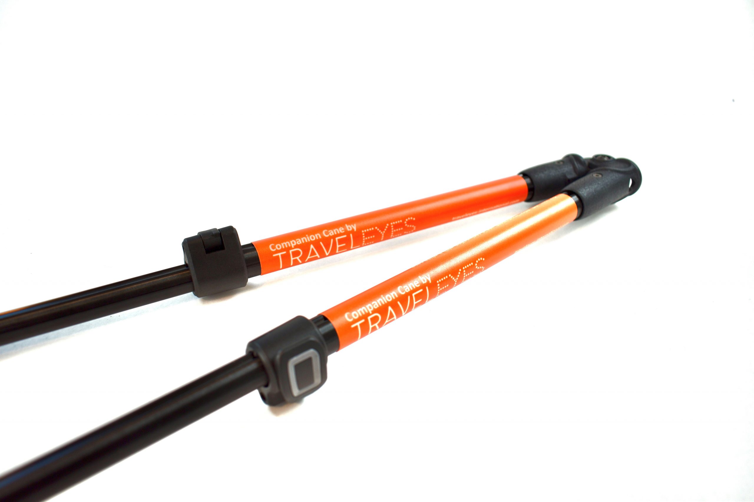 Photo description: A close up showing the two inner poles with the orange TE labels, the clasps used to hold the poles length and the black hinge that allows the cane to fold