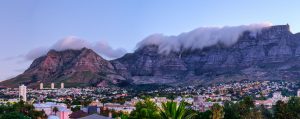 Dusk view of Table mountain with a cloud "blanket" towering over Cape Town below