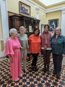 Marsha, Shellas, Carol, Connie and Molly dressed up for the last dinner in the grand entrance of Newfield Hall.