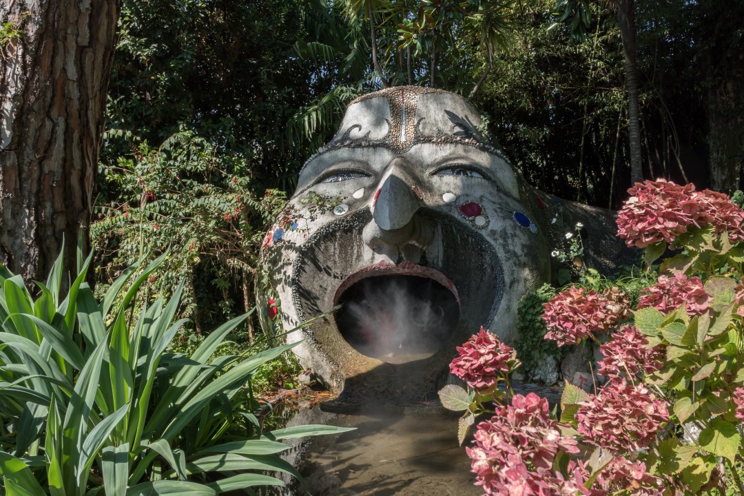 André Heller Botanical Garden A large smiling stone sculpture in the Anima Garden