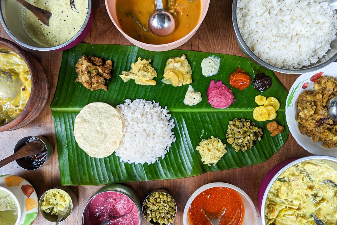 A traditional south Indian thali served on a fresh green palm leaf