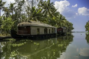 A houseboat cruises slowly down the backwaters of Kerala