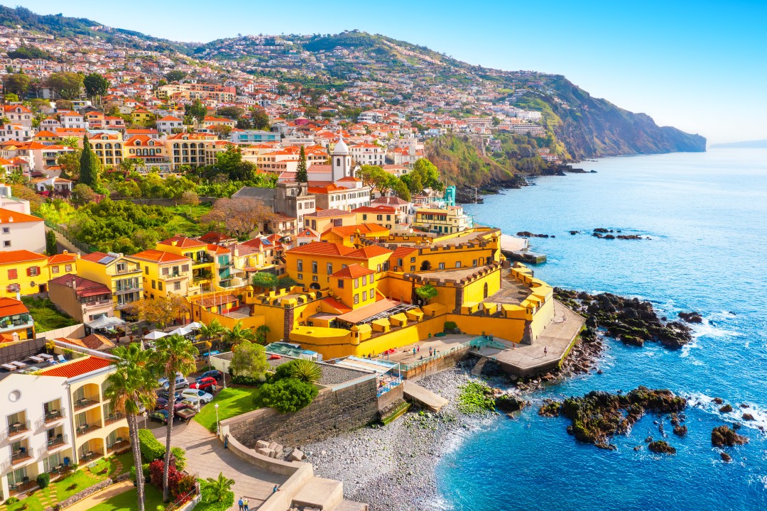 Funchal Old Town and São Tiago Fort Aerial view of Funchal’s colourful old town and yellow São Tiago Fort beside the rocky Atlantic coastline