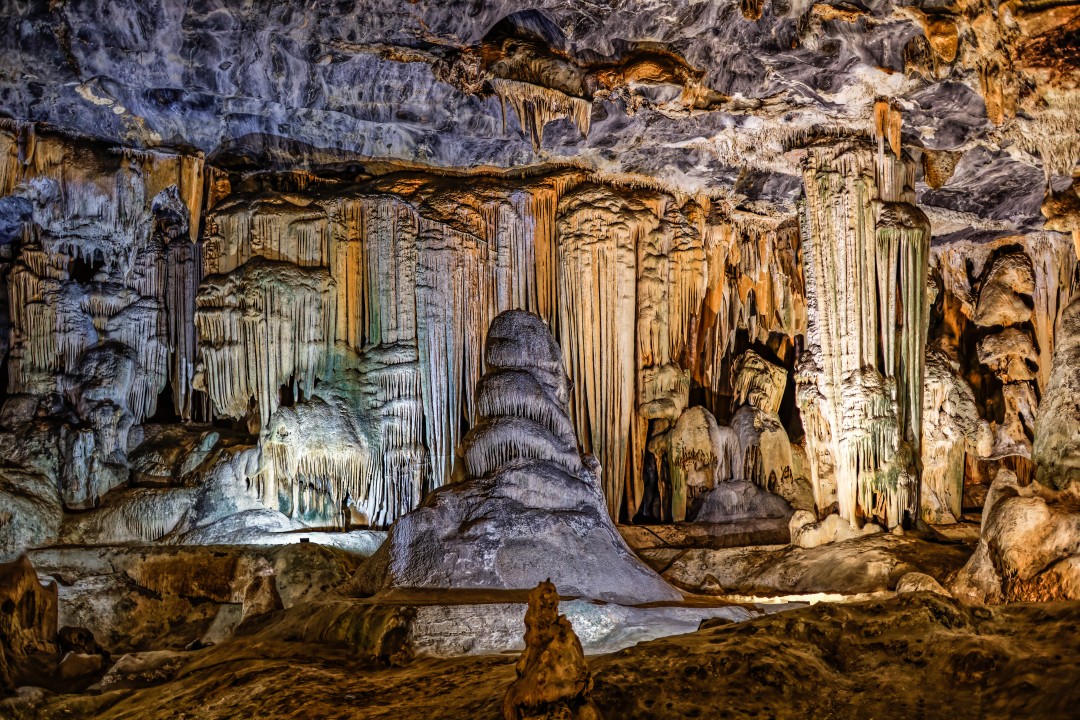 Illuminated stalactites, stalagmites and flowing limestone formations inside the Cango Caves near Oudtshoorn