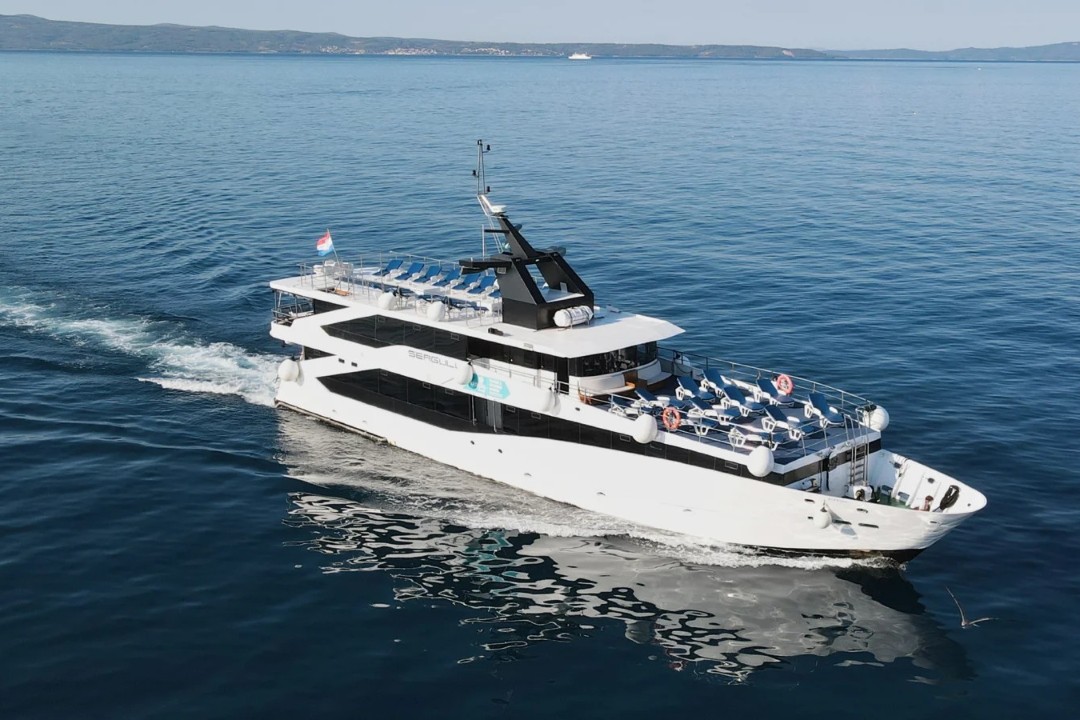 Seagull motor yacht sailing across the calm blue Adriatic Sea, Croatia