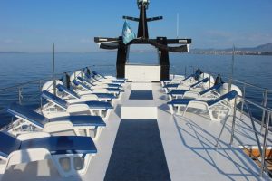 Sun loungers arranged across the open upper deck of Seagull with views over the Adriatic Sea