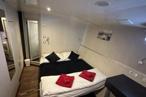 Double cabin aboard Seagull with a made-up bed, private bathroom access and modern interior