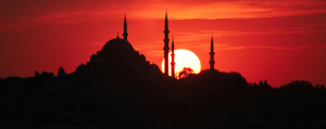 Silhouette of the minarets of the blue mosque again a deep red sunset