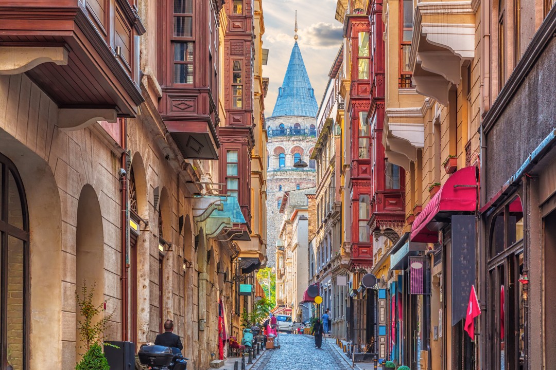 Turkish street by the Galata Tower Narrow cobbled street lined with colourful buildings leading towards Galata Tower, Istanbul