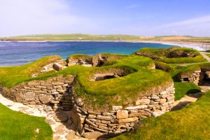 Stone-built Neolithic homes at Skara Brae beside the coast, Orkney Islands