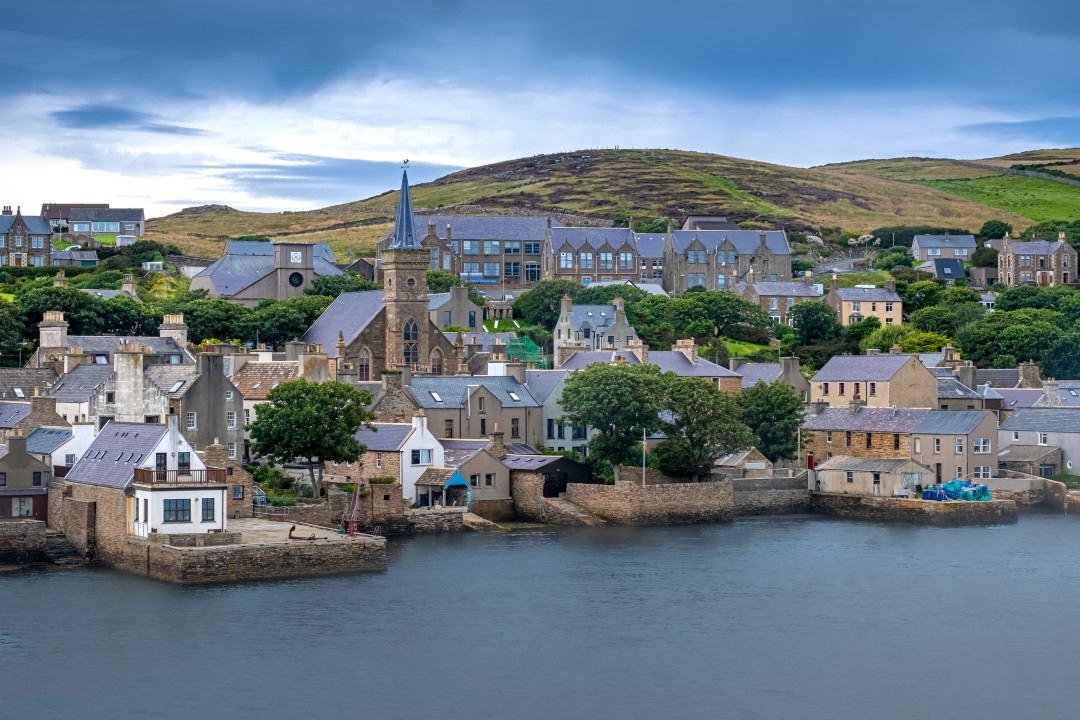 Stromness Waterfront Stone houses and church buildings line the waterfront in Stromness, Orkney Islands