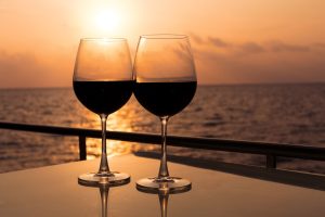 Two glasses of wine waiting to be enjoyed onboard a yacht at sunset